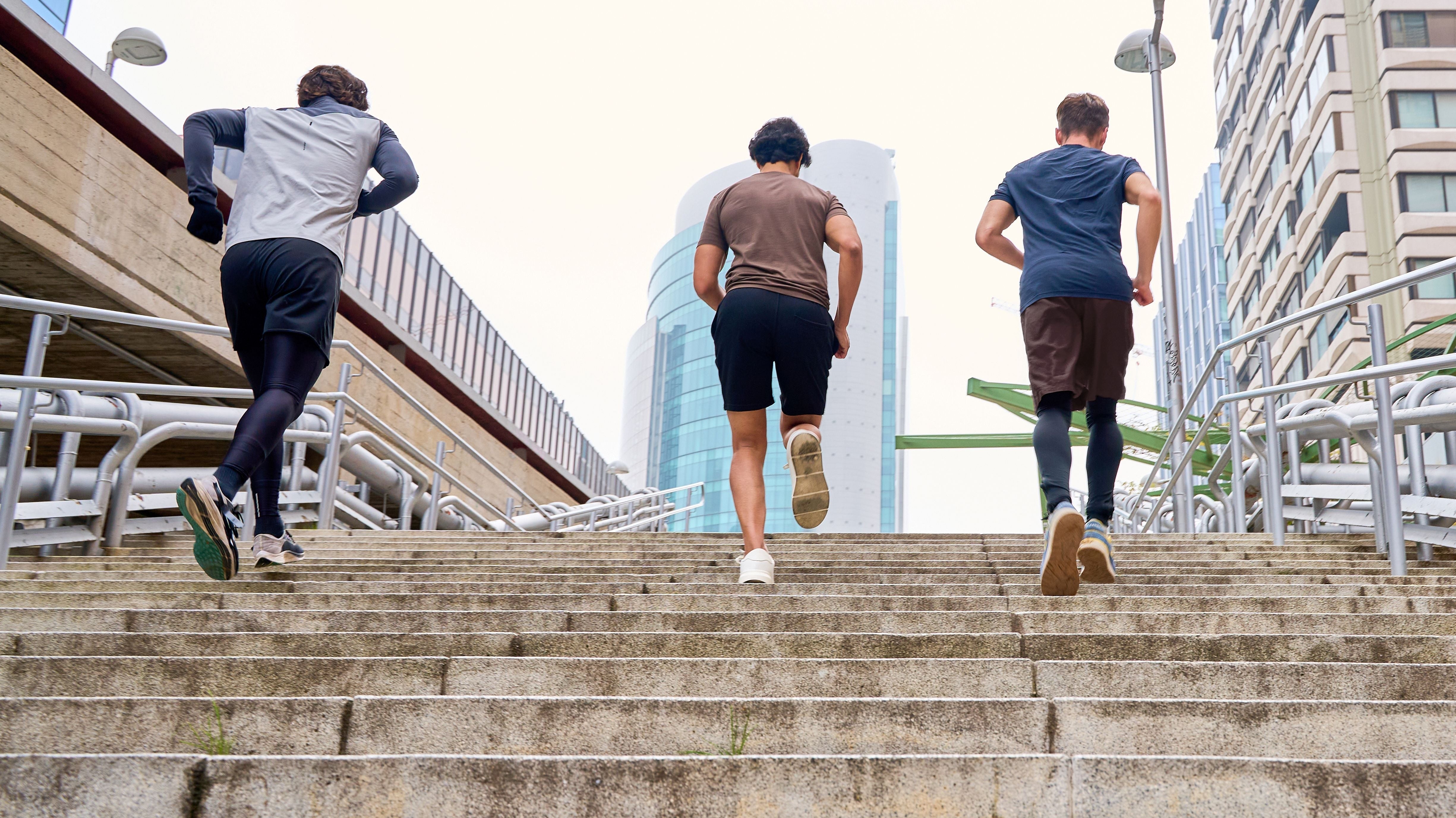 Athletes running up stairs
