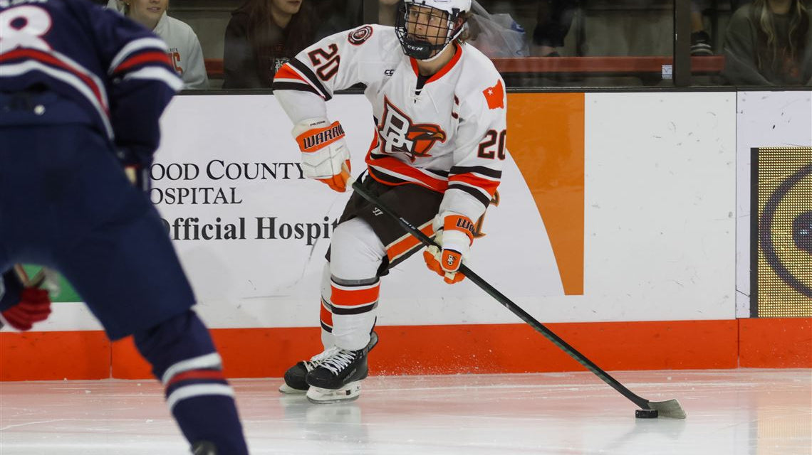 College hockey player about to pass