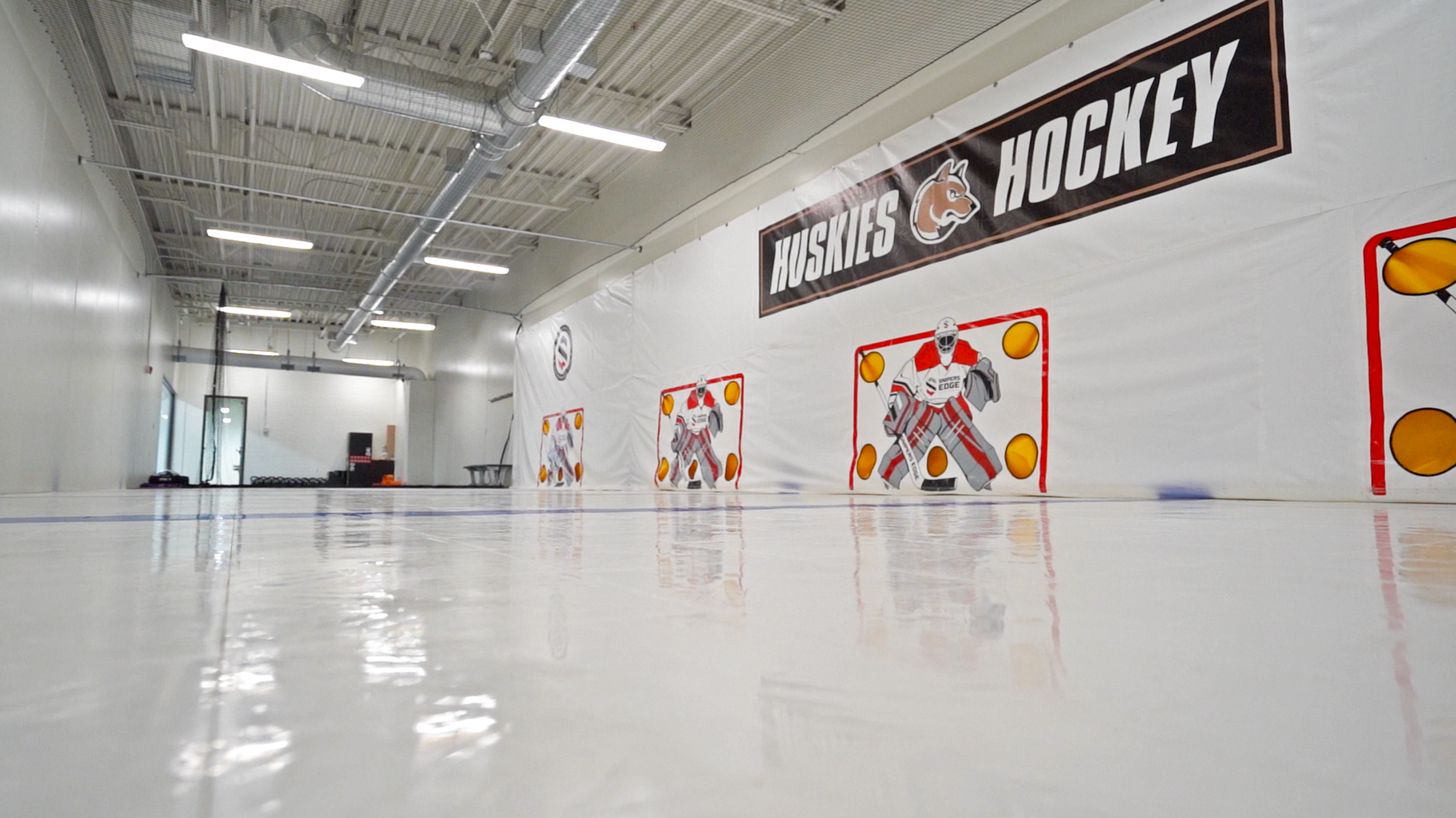 Training center in Andover, MN featuring Snipers Edge dryland hockey tiles and shooting tarps