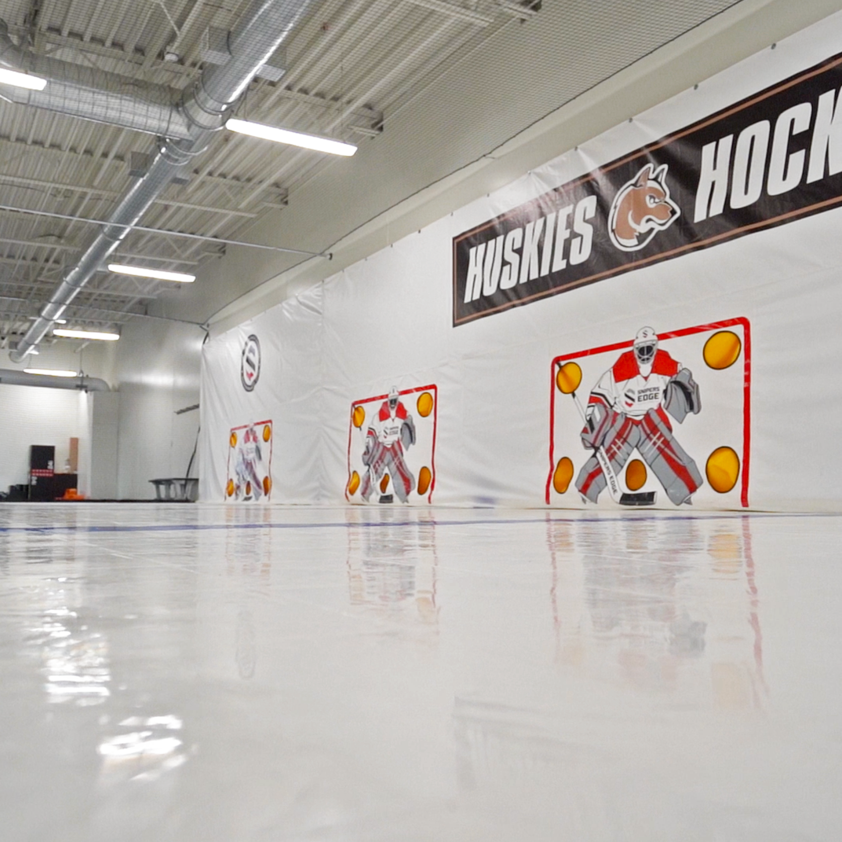 Training center in Andover, MN featuring Snipers Edge dryland hockey tiles and shooting tarps