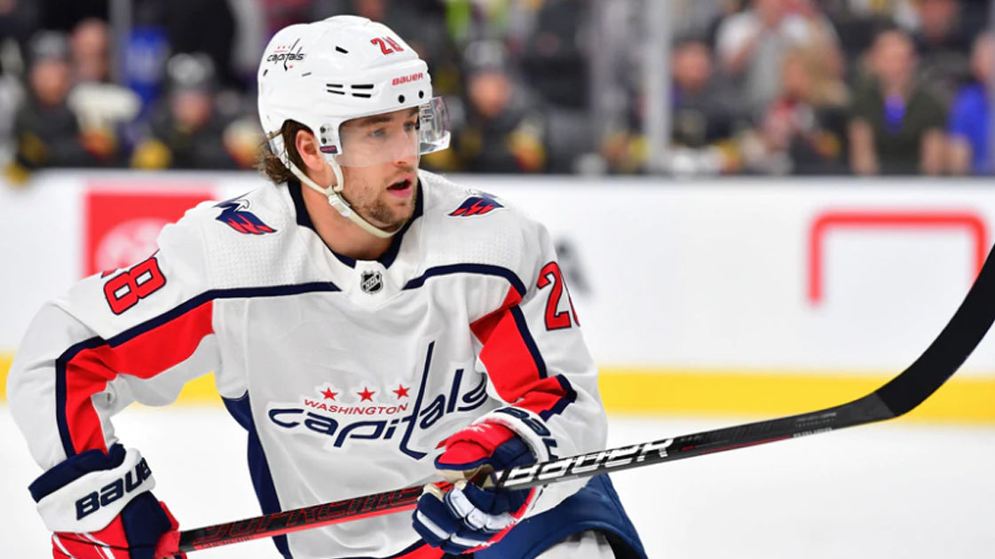 Hockey Player playing in a game with a large crowd watching