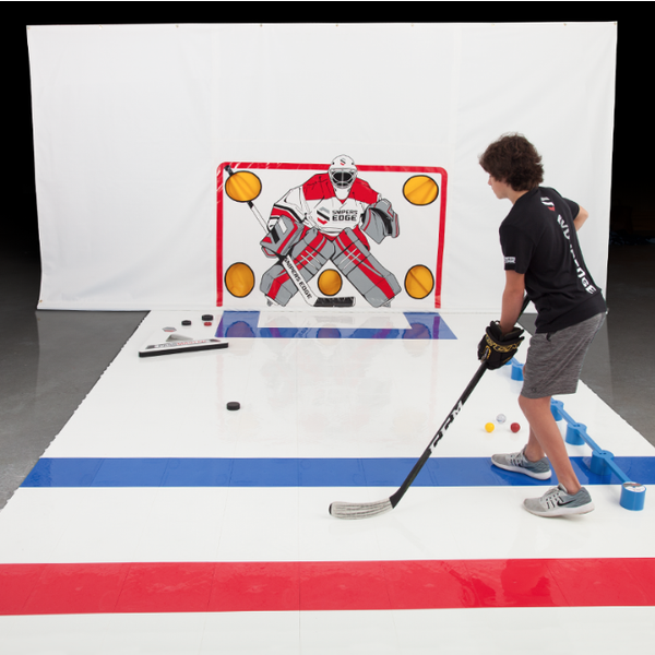 A kid practicing hockey skills indoors using our Slick Tiles