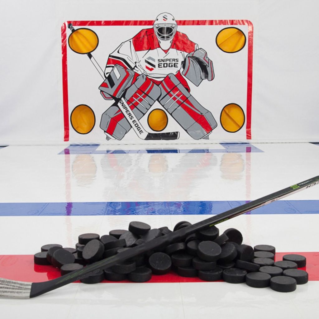 Pile of pucks with hockey shooting tarp and dryland hockey tiles