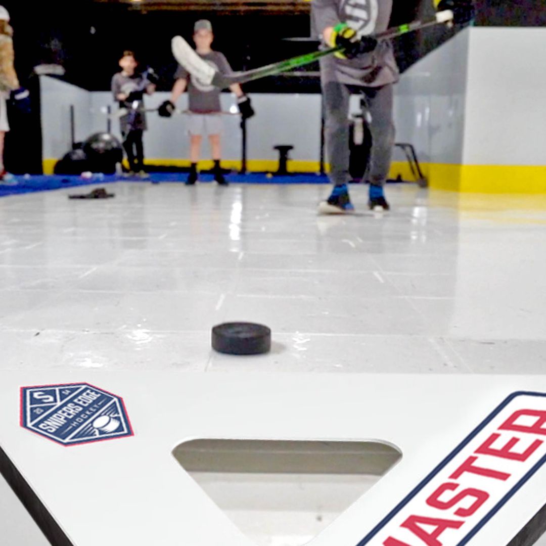 kid passing the puck to a passmaster