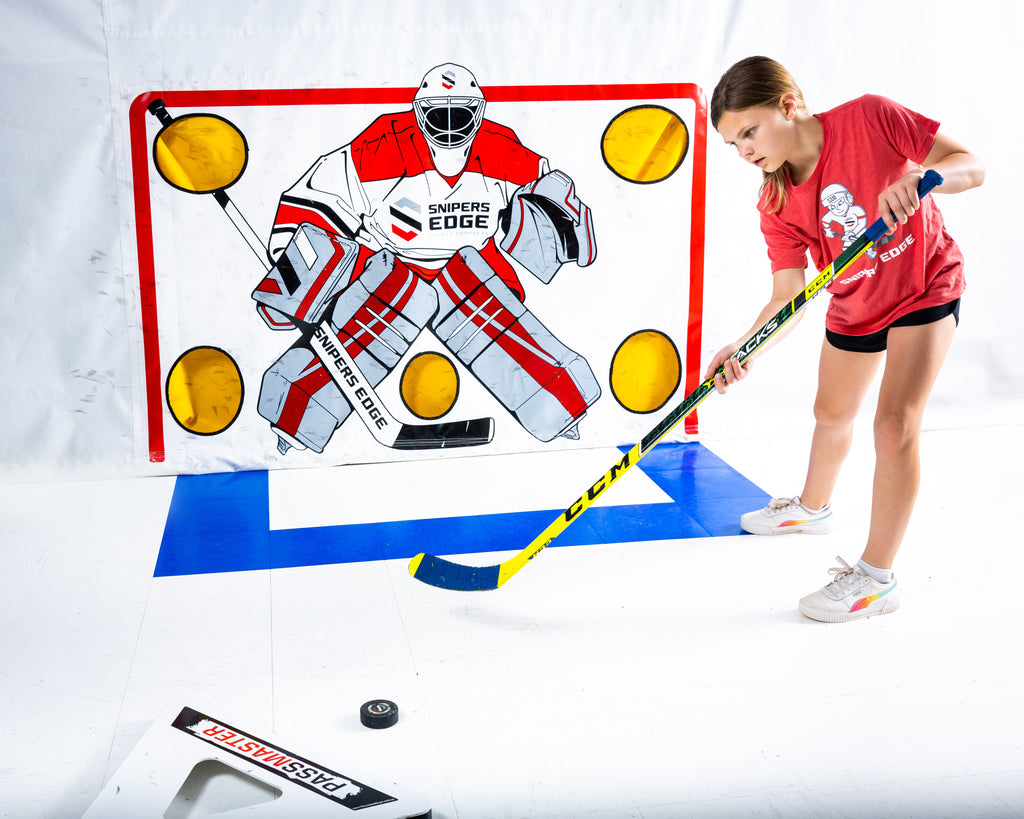 Girl practing hockey while wearing her SNIPER SAM KIDS T-SHIRT