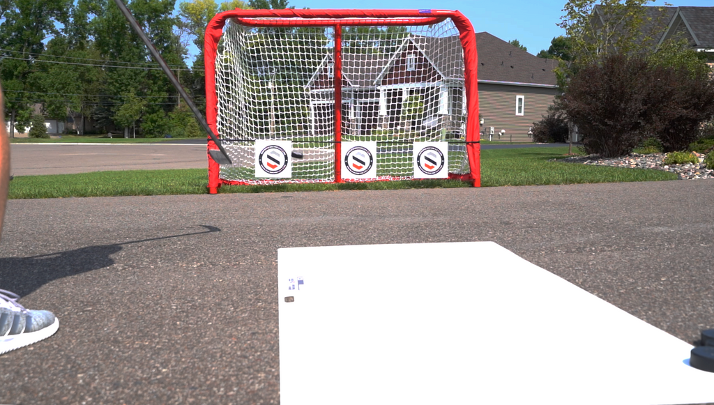 Outside Goal Practicing Hockey Shooting with Targets 