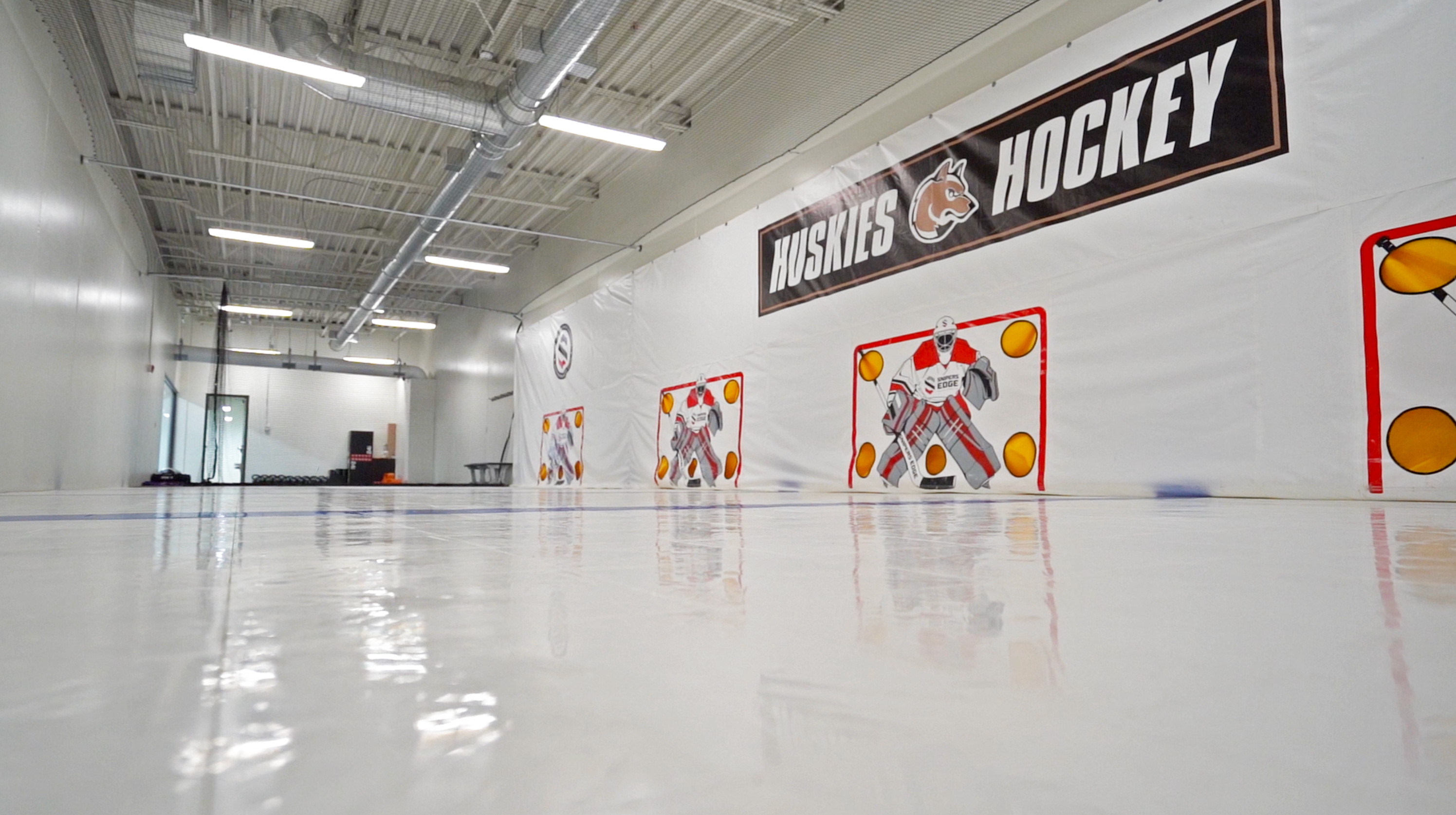 Training center in Andover, MN featuring Snipers Edge dryland hockey tiles and shooting tarps