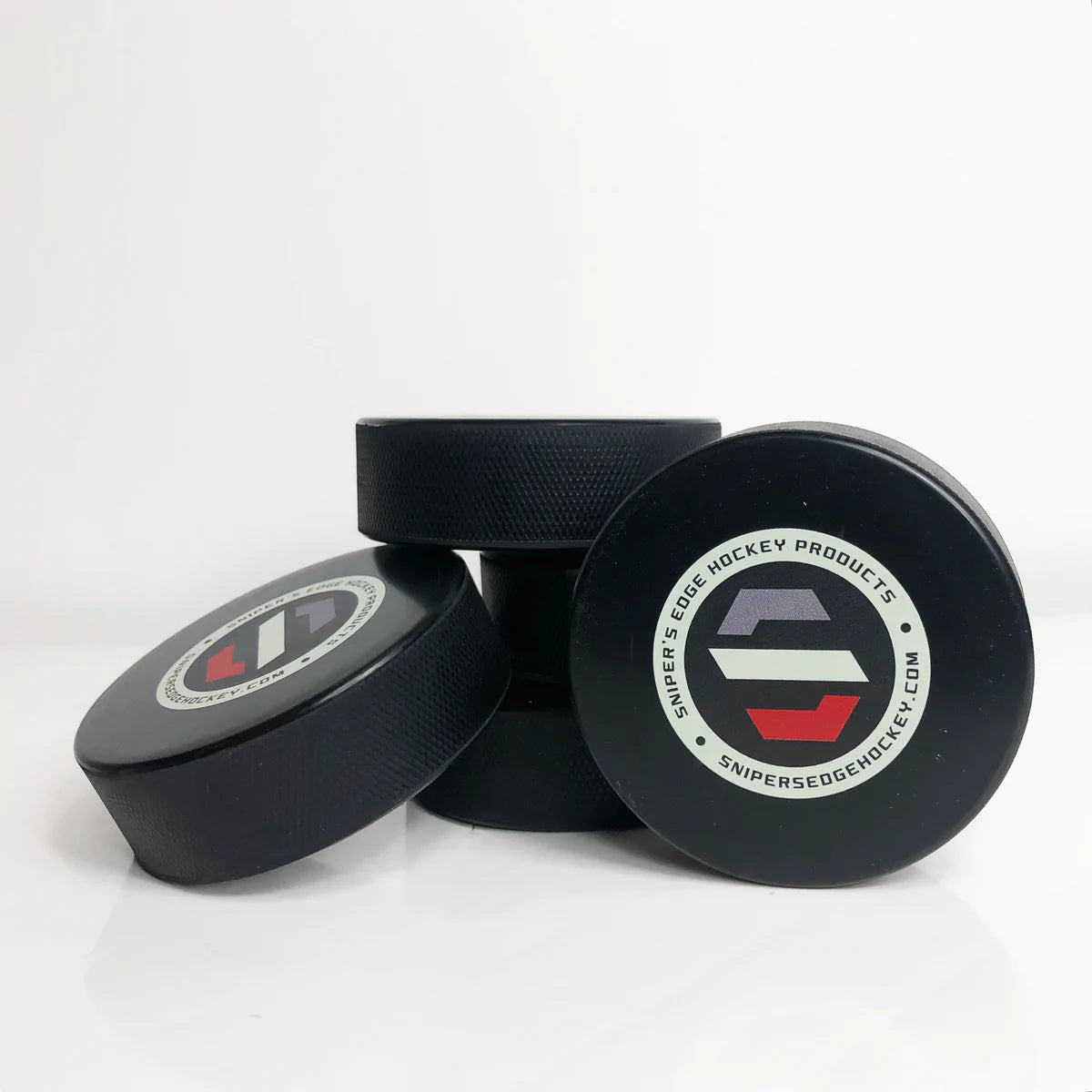 Stack of Snipers logo pucks