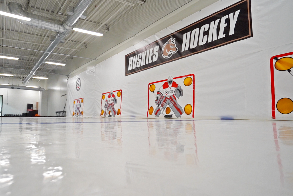 Custom shooting tarp with "Huskies Hockey" logo