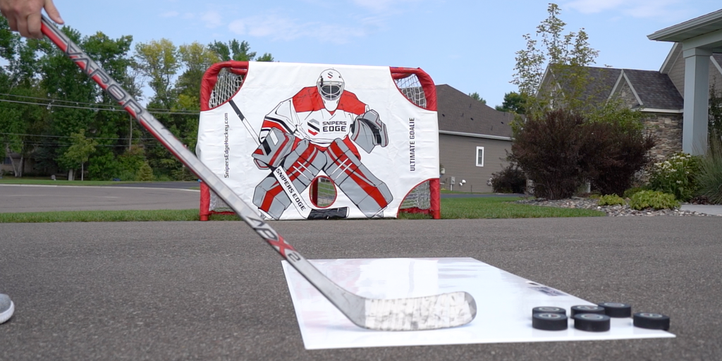 Player shooting into an Ultimate Goalie on their driveway