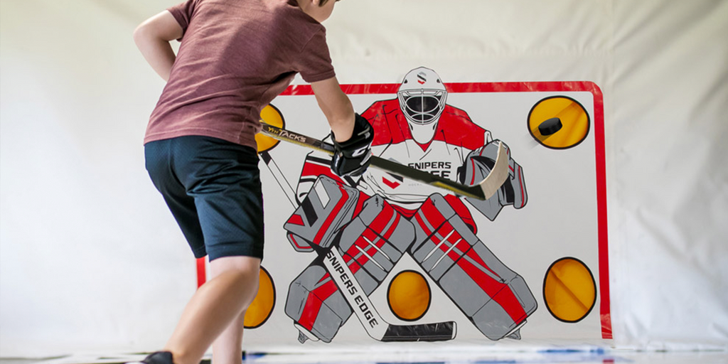 Youth player shooting on Snipers Edge Shooting Tarp in a garage
