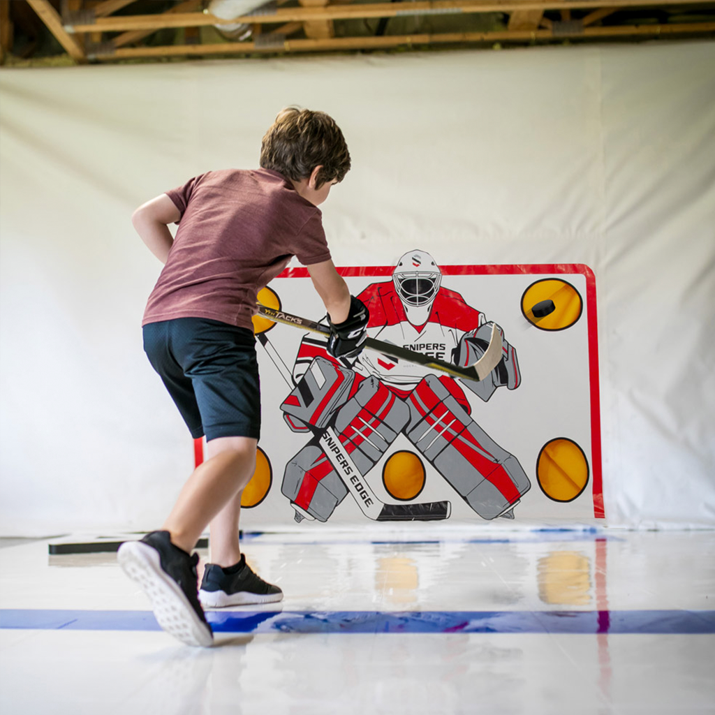 Youth player shooting on Snipers Edge Shooting Tarp in a garage