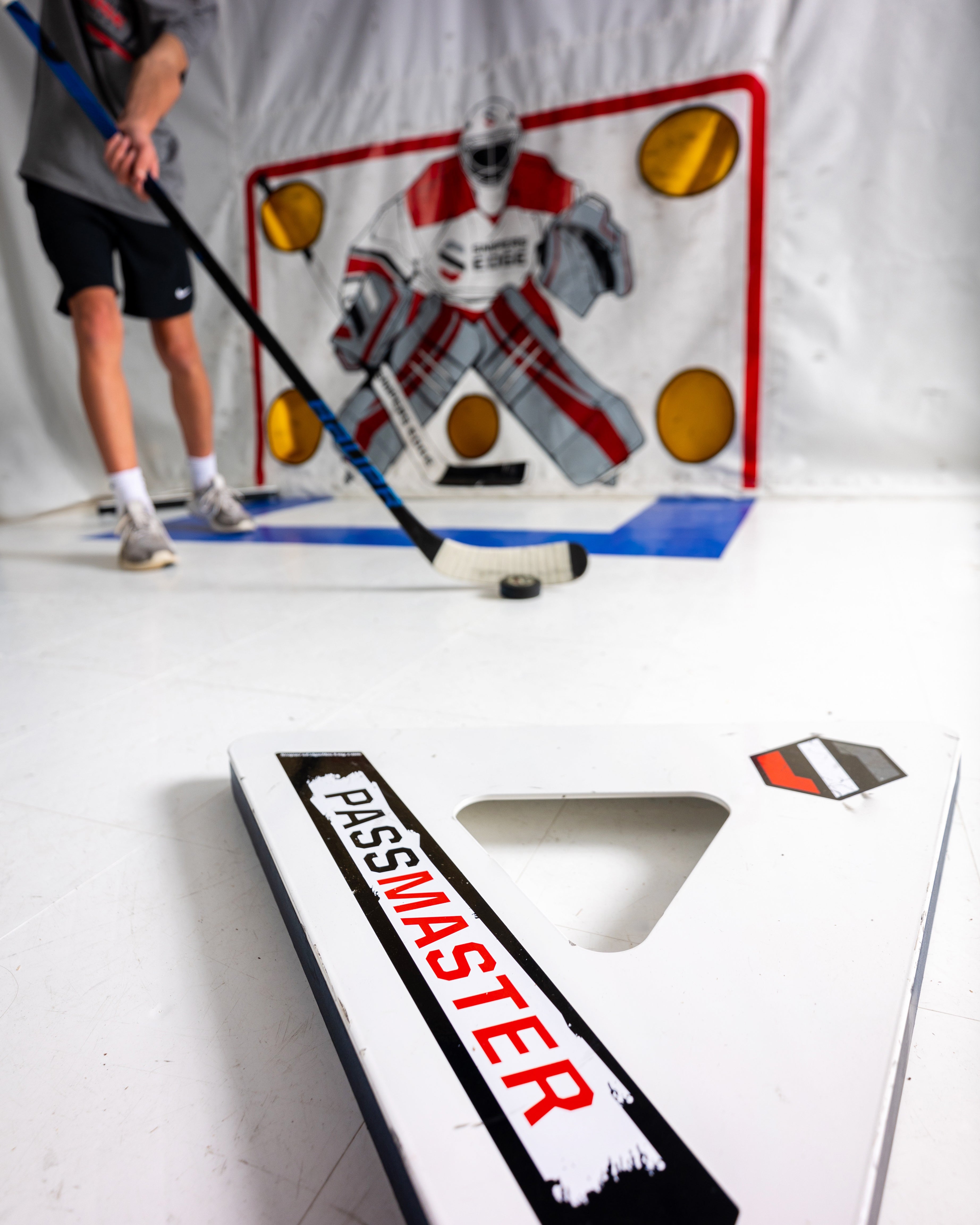 Close up image of passmaster, white tiles and shooting tarp in background