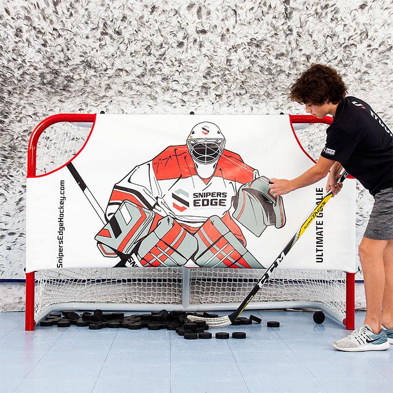 Youth player lifting ultimate goalie with draw string to retrieve pucks