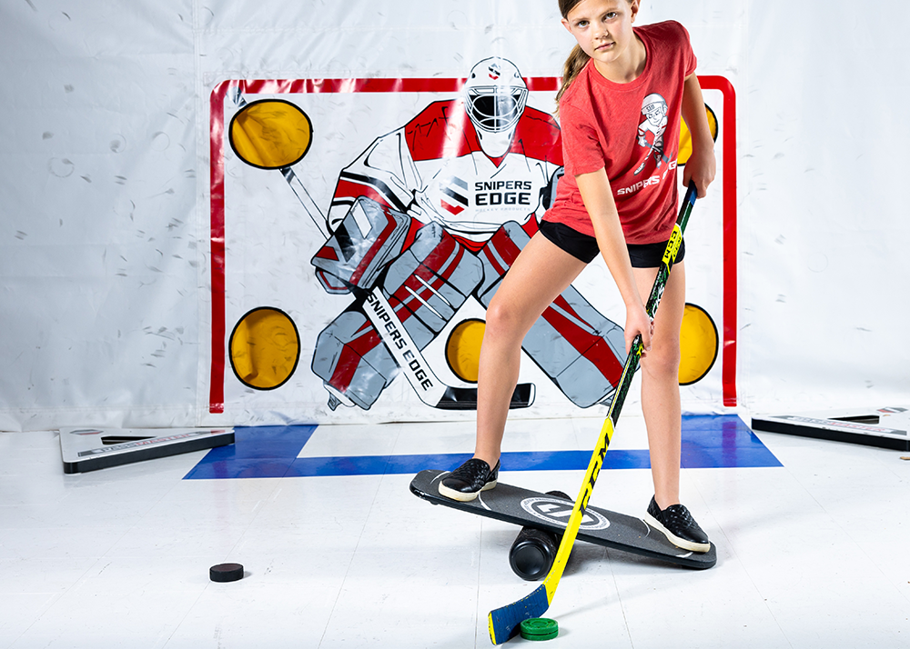 a player on the balance board holding a hockey stick