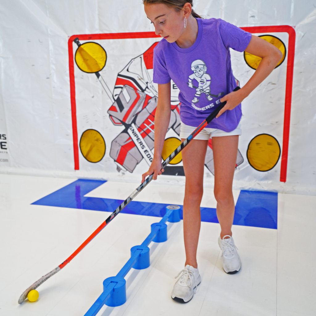 Girl in purple Sniper Sam shirt using yellow speed ball with Sweethands